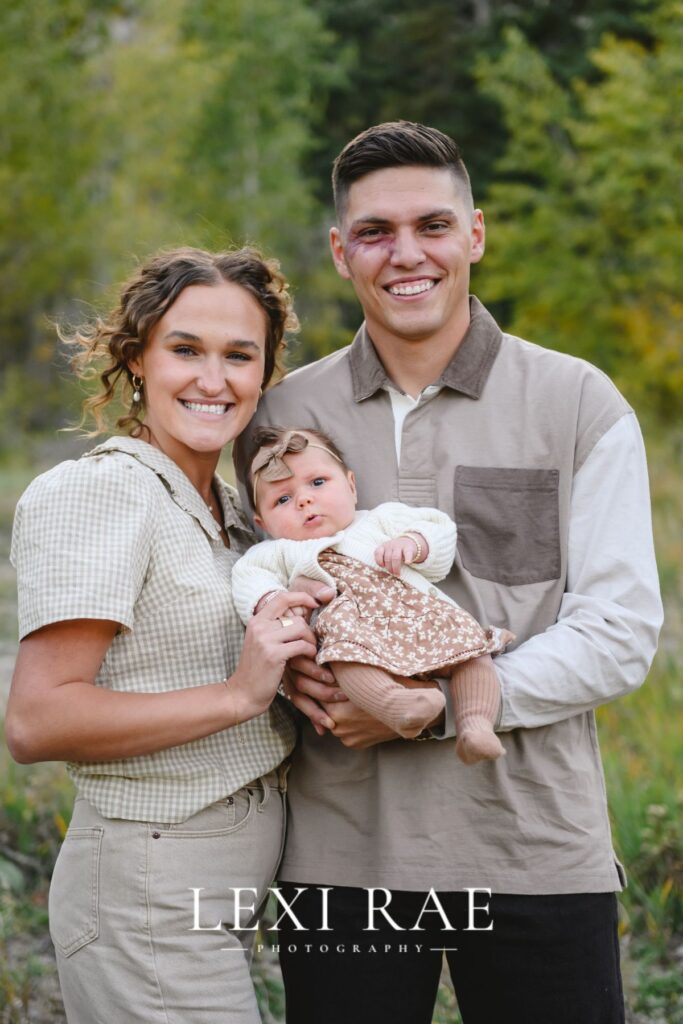 family of three smiling in a utah family portrait