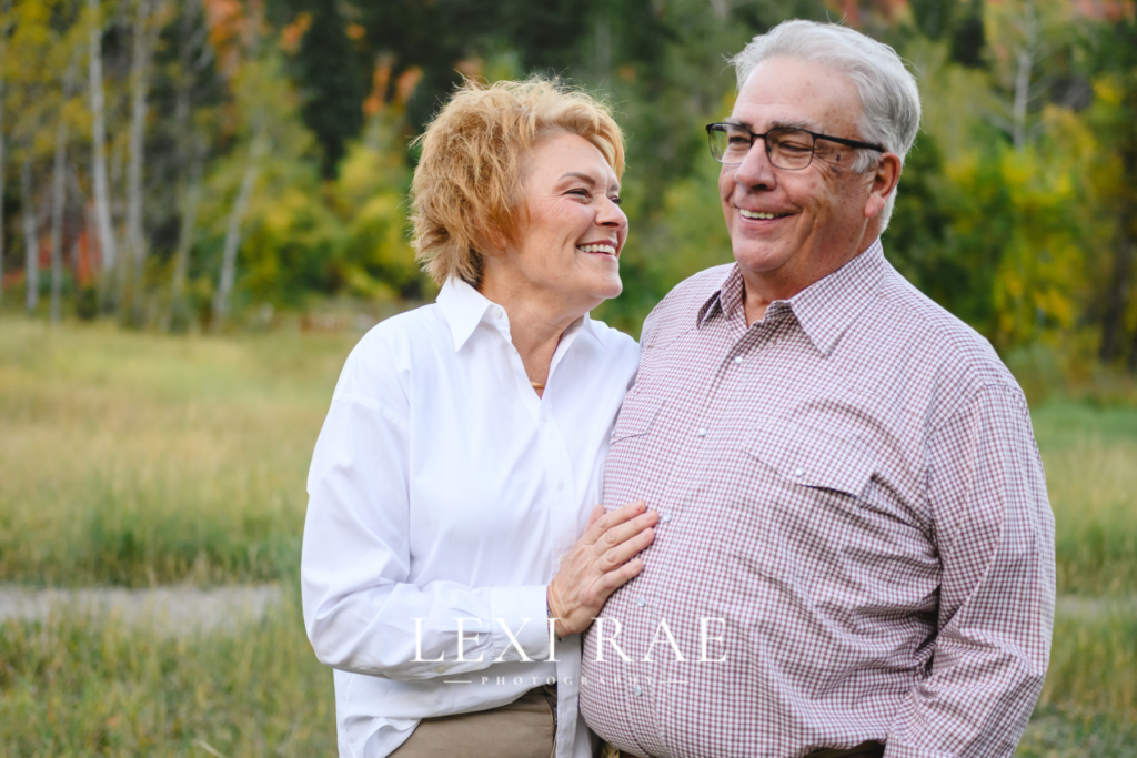 Older couple laughing together in the mountains of Park City