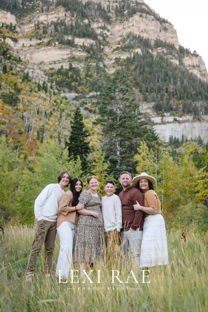 Family gathered together for a photograph in the mountains of Park City, Utah with the fall foliage in the background. 