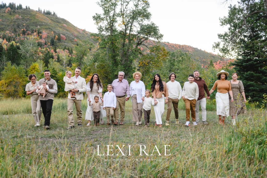 Large extended family photo. In the mountains of Park City, Utah with the fall foliage in the background. 