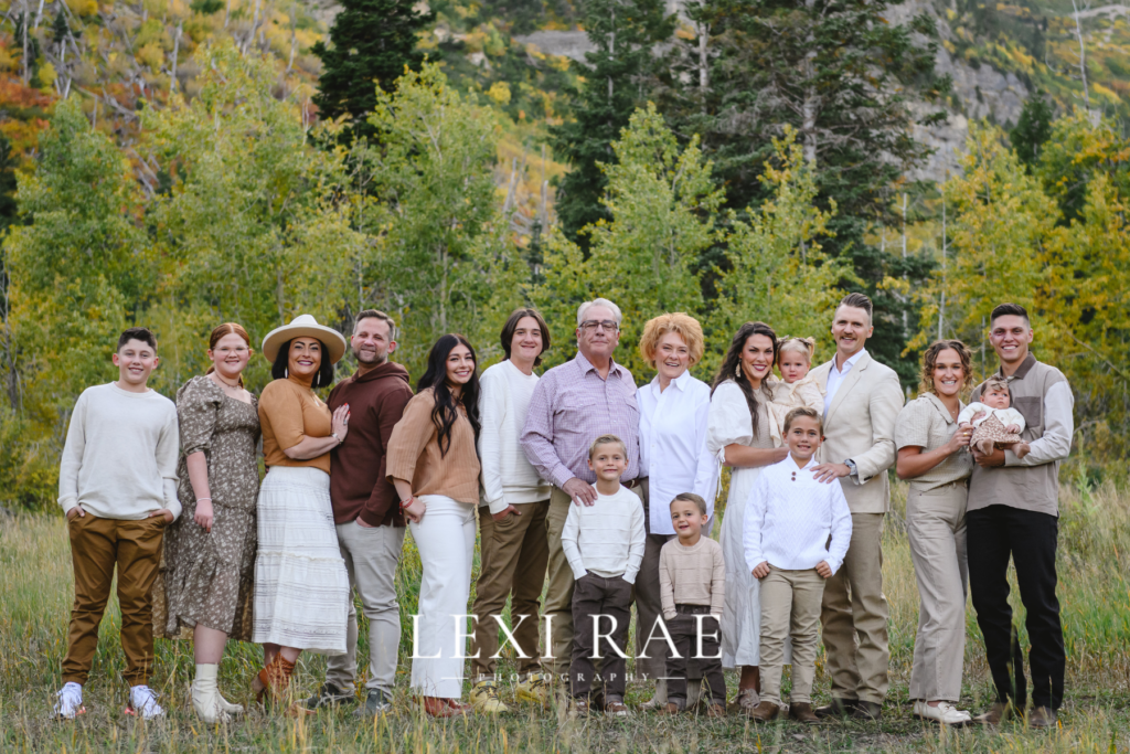 Large extended family photo. In the mountains of Park City, Utah with the fall foliage in the background. 