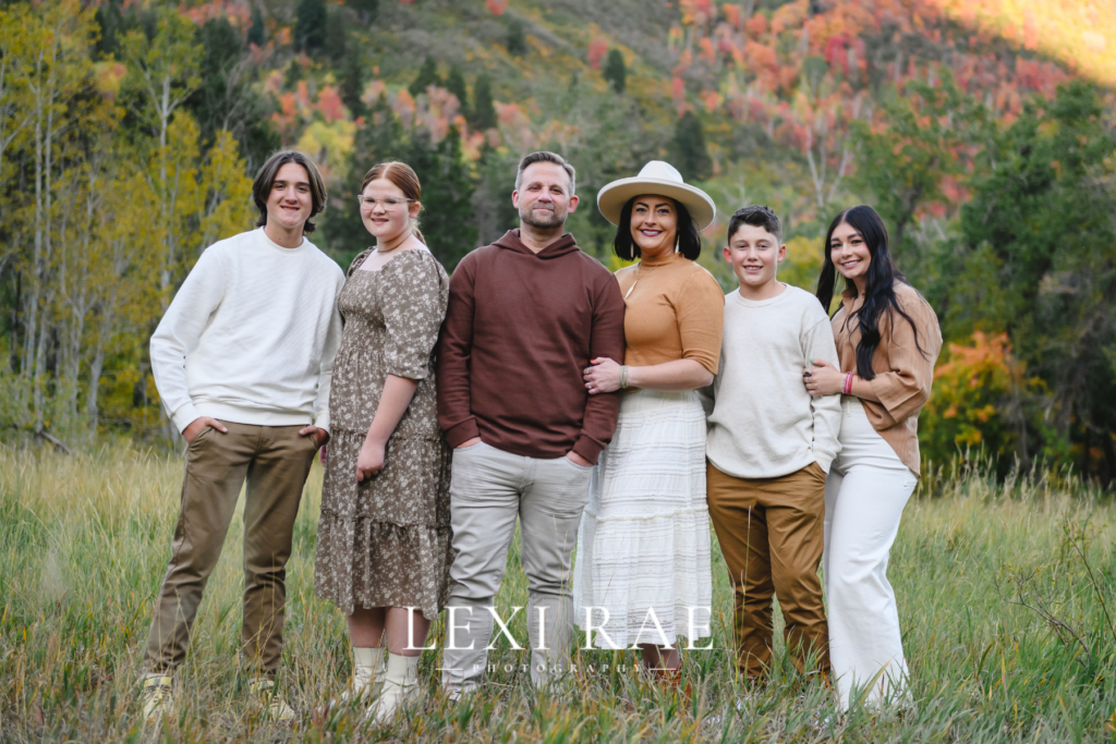 Large extended family photo. In the mountains of Park City, Utah with the fall foliage in the background. 