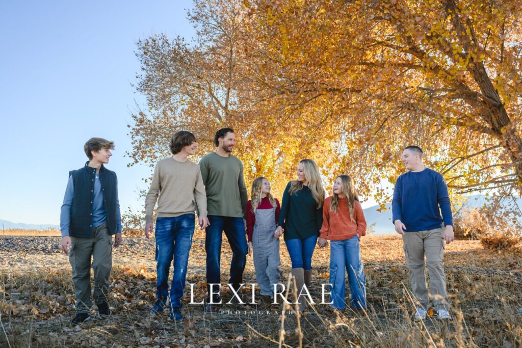 Family wearing casual outfits in fall leaves in Park City Utah