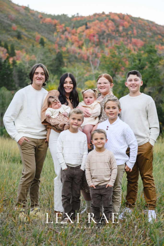 Large extended family photo. In the mountains of Park City, Utah with the fall foliage in the background. 