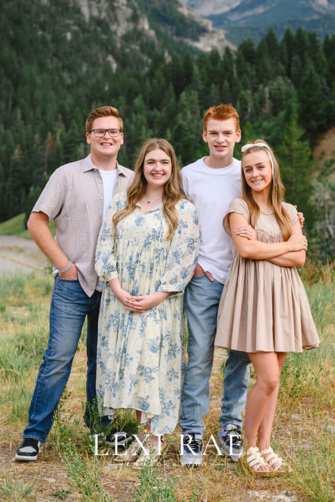 Siblings posing for a photo. Hands in pockets, hands held and arms crossed. 