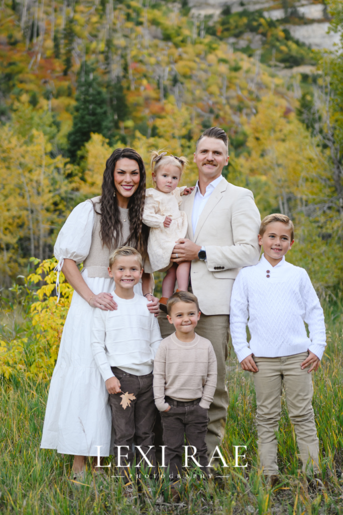 Capturing a family photo. In the mountains of Park City, Utah with the fall foliage in the background. 