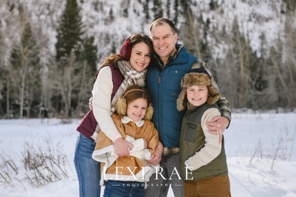 Family photography session in Provo Utah. Family wearing coats and layers in the Utah snowy mountains. 